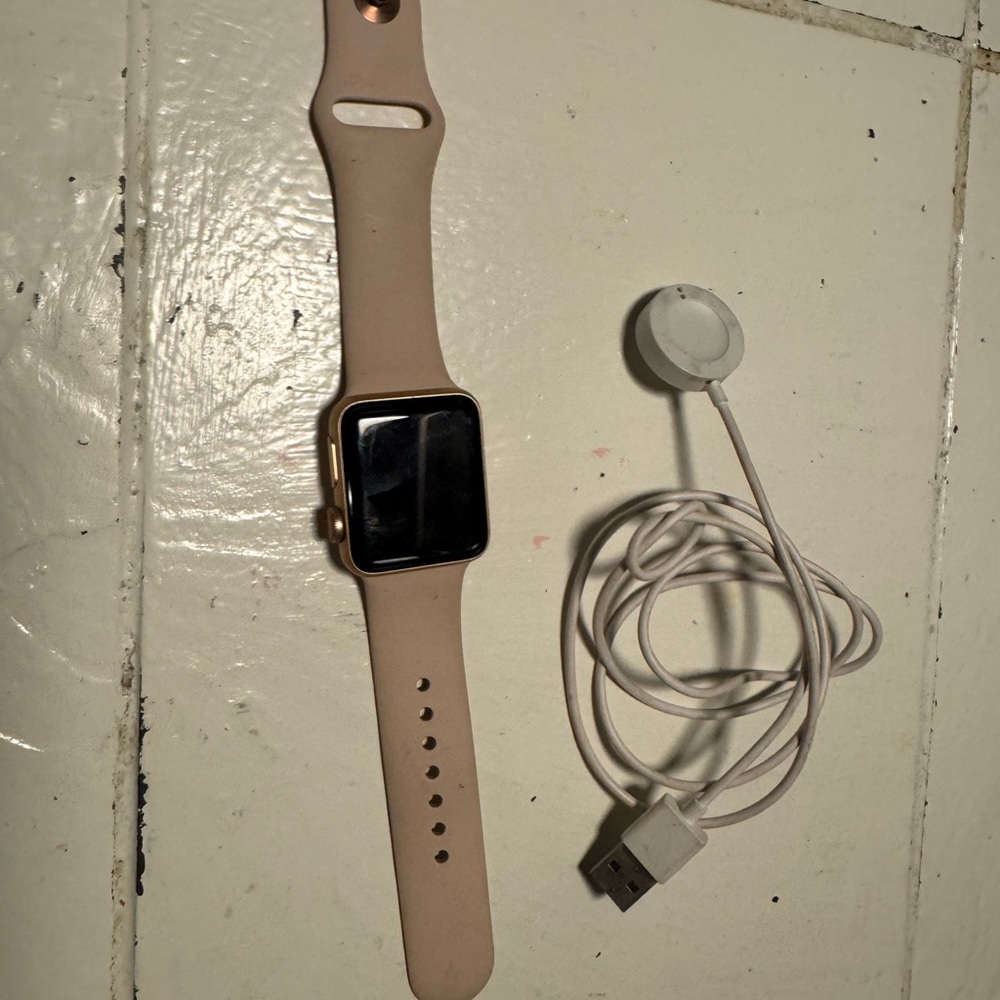 Apple Watch Series 3 (38mm) with a pink band.
